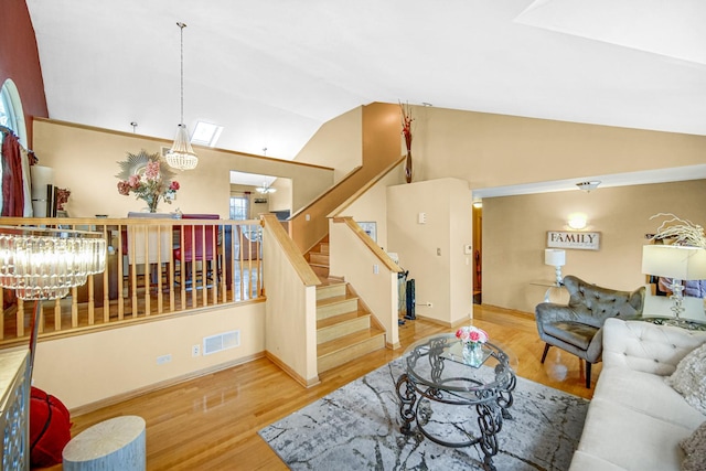 513 Wallace St, Chicago Heights, IL 60411 - living area with a chandelier, visible vents, wood finished floors, stairway, and lofted ceiling