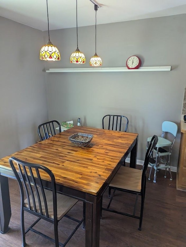 dining area featuring baseboards and wood finished floors