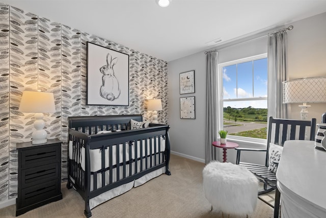 carpeted bedroom with baseboards and an accent wall