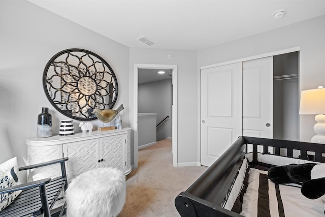 carpeted bedroom with baseboards, visible vents, and a closet