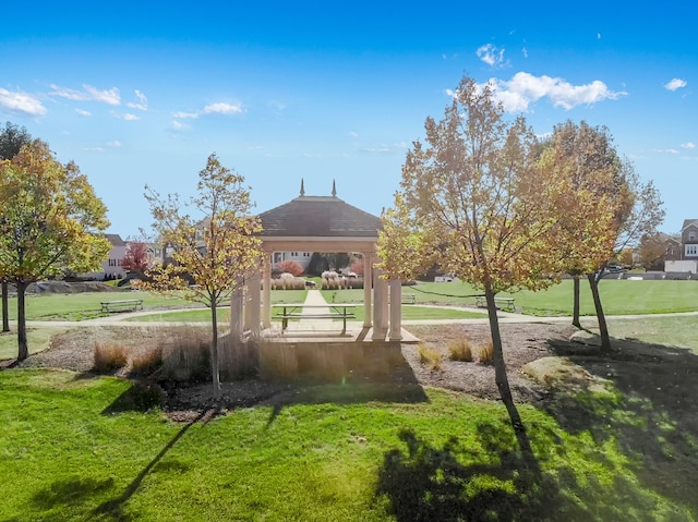 surrounding community with a gazebo and a yard