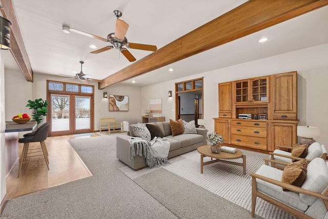 living area with recessed lighting, a ceiling fan, wood finished floors, and beamed ceiling