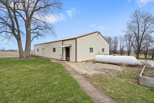 rear view of house featuring a lawn