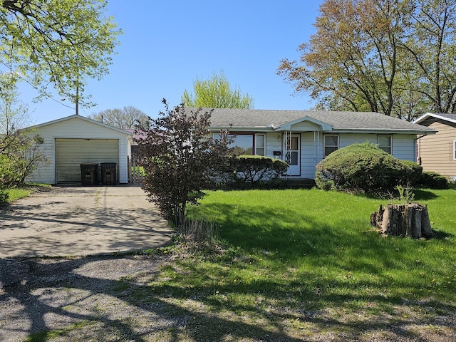 ranch-style home with an outbuilding, a front yard, and concrete driveway