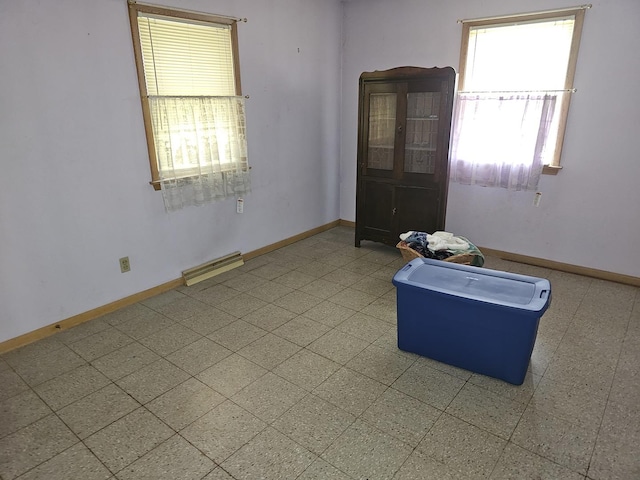 spare room with baseboards and visible vents