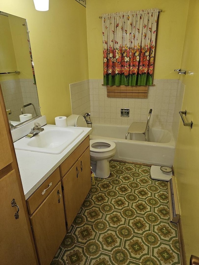 full bathroom with vanity, a garden tub, and toilet