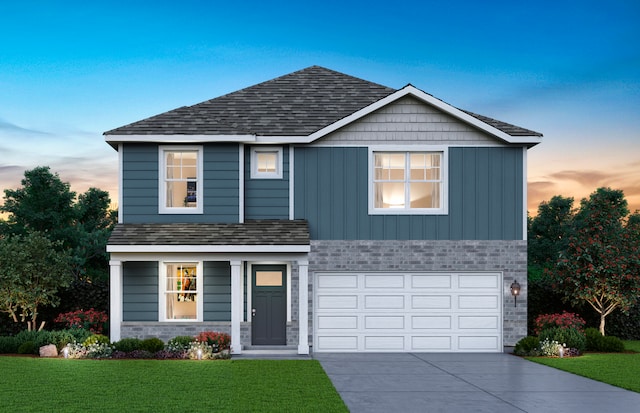 traditional-style house with a garage, driveway, stone siding, board and batten siding, and a yard