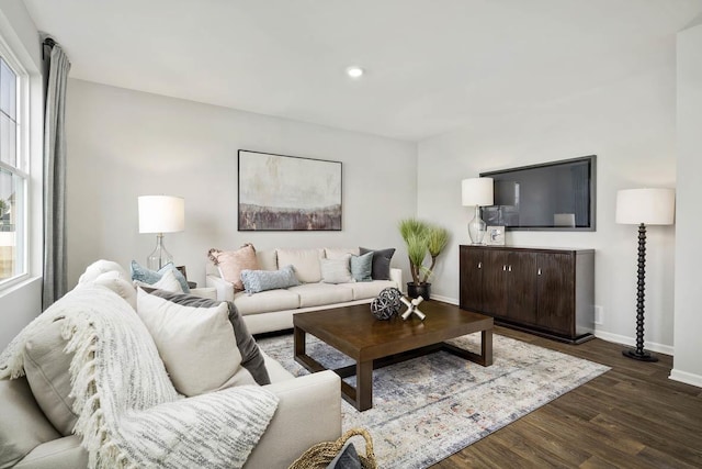 living room featuring recessed lighting, baseboards, and dark wood-style floors