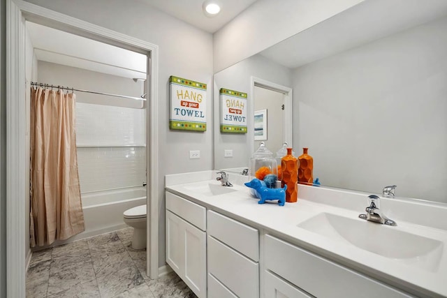bathroom featuring a sink, toilet, double vanity, and shower / tub combo