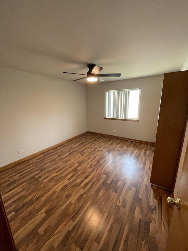 425 Tamarack St, Park Forest, IL 60466 - empty room with dark wood-type flooring and ceiling fan