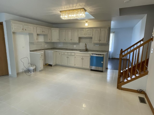 425 Tamarack St, Park Forest, IL 60466 - kitchen with stainless steel dishwasher, tasteful backsplash, a chandelier, light countertops, and light tile patterned floors
