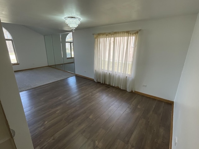 425 Tamarack St, Park Forest, IL 60466 - spare room with healthy amount of natural light, dark wood-style flooring, a chandelier, and vaulted ceiling