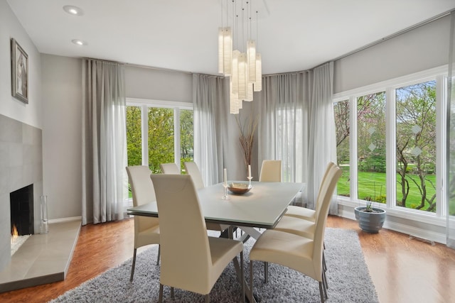 12 Forest Ln, South Barrington, IL 60010 - dining area with a tiled fireplace, recessed lighting, baseboards, wood finished floors, and visible vents