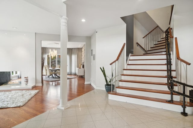 12 Forest Ln, South Barrington, IL 60010 - staircase with baseboards, tile patterned flooring, recessed lighting, and ornate columns
