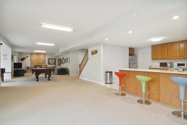 12 Forest Ln, South Barrington, IL 60010 - kitchen with a breakfast bar area, light countertops, stainless steel microwave, freestanding refrigerator, and open floor plan