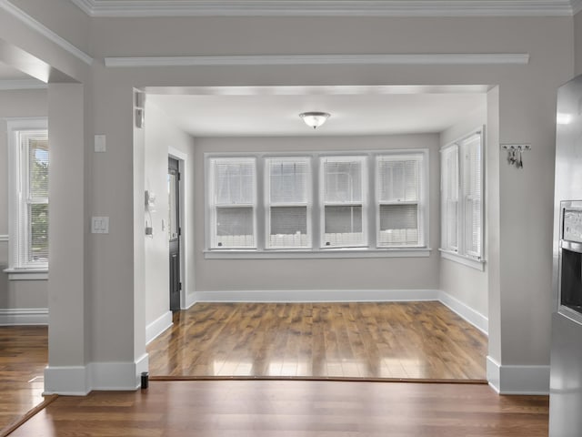 908 Superior St, Aurora, IL 60505 - unfurnished dining area with wood finished floors, baseboards, and crown molding