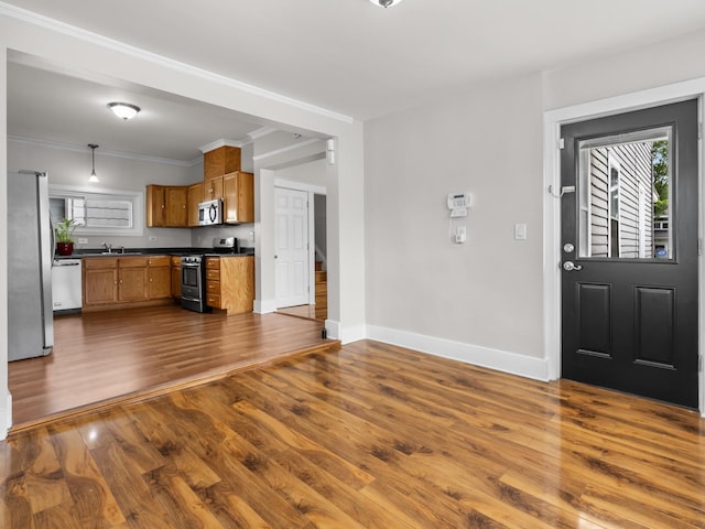 908 Superior St, Aurora, IL 60505 - kitchen with stainless steel appliances, dark countertops, dark wood-type flooring, brown cabinets, and baseboards