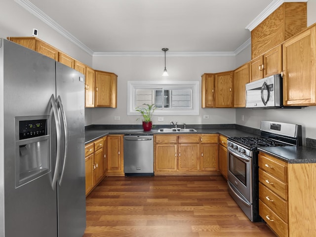 908 Superior St, Aurora, IL 60505 - kitchen featuring stainless steel appliances, a sink, dark countertops, crown molding, and dark wood-style floors