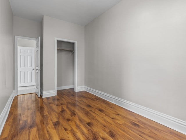 908 Superior St, Aurora, IL 60505 - unfurnished bedroom featuring dark wood finished floors, baseboards, and a closet