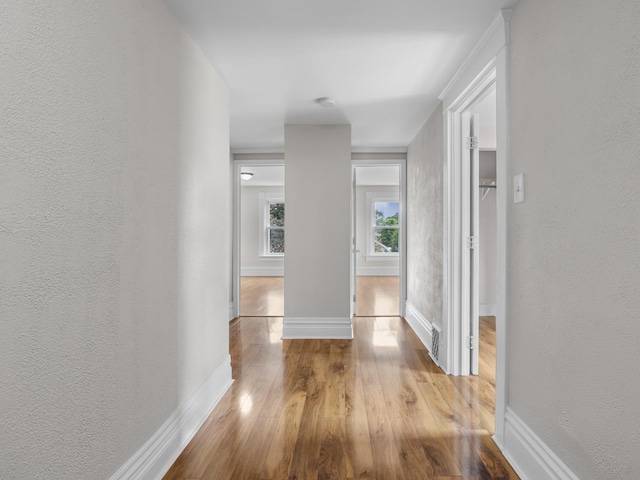 908 Superior St, Aurora, IL 60505 - hall with a textured wall, wood finished floors, and baseboards