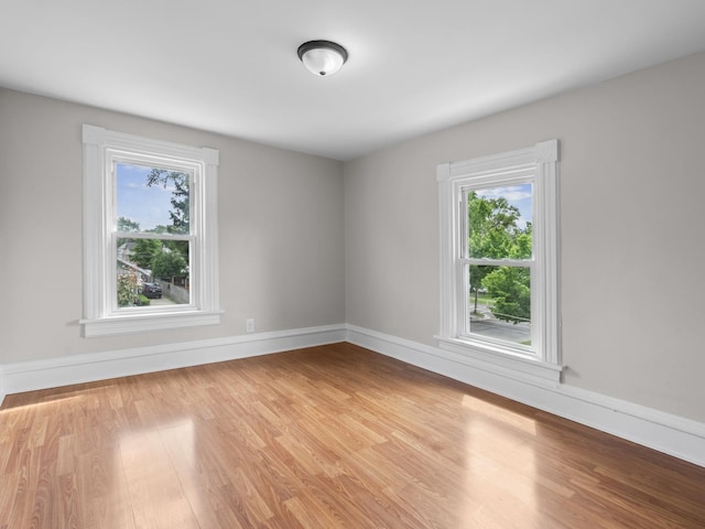 908 Superior St, Aurora, IL 60505 - empty room with healthy amount of natural light, light wood finished floors, and baseboards