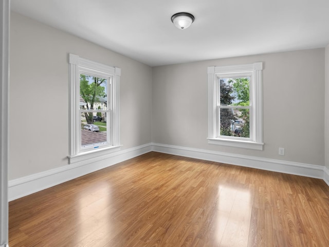 908 Superior St, Aurora, IL 60505 - empty room with healthy amount of natural light, wood finished floors, and baseboards