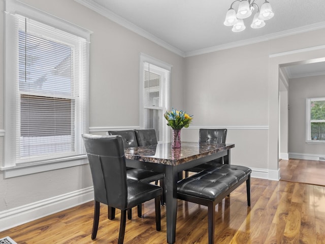 908 Superior St, Aurora, IL 60505 - dining space featuring a chandelier, ornamental molding, wood finished floors, and baseboards