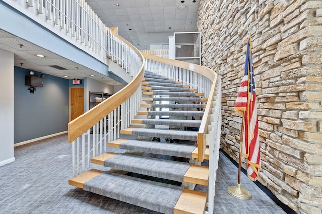 9701 N Dee Rd Unit 1B, Niles, IL 60714 - staircase featuring baseboards, a drop ceiling, and carpet