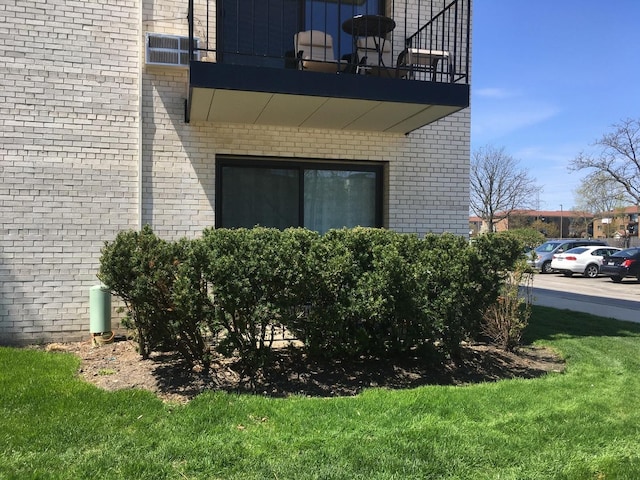 9701 N Dee Rd Unit 1B, Niles, IL 60714 - view of property exterior featuring brick siding, a lawn, and a balcony