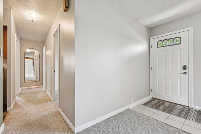 27 Arlington Dr, Romeoville, IL 60446 - carpeted foyer entrance featuring a textured ceiling, baseboards, and tile patterned floors