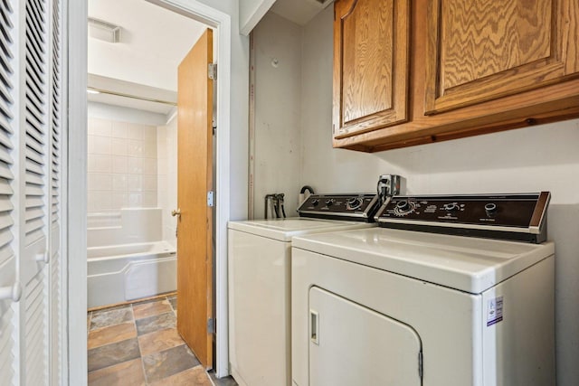 27 Arlington Dr, Romeoville, IL 60446 - clothes washing area featuring cabinet space, washer and clothes dryer, and stone finish flooring