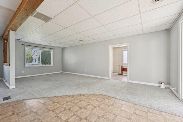 27 Arlington Dr, Romeoville, IL 60446 - unfurnished living room with light colored carpet, a paneled ceiling, baseboards, and light floors