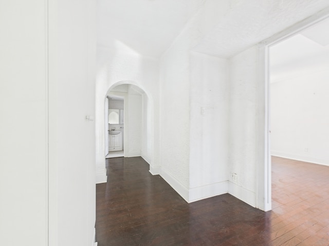 5555 S Everett Ave Unit B3-4, Chicago, IL 60637 - interior space featuring arched walkways, dark wood-style floors, and baseboards