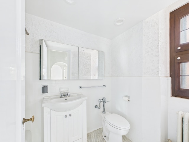 5555 S Everett Ave Unit B3-4, Chicago, IL 60637 - bathroom with radiator, toilet, tile patterned flooring, and vanity