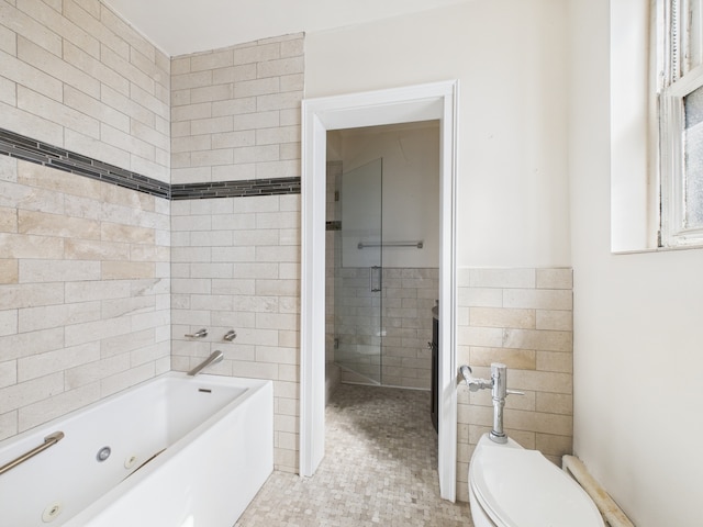 5555 S Everett Ave Unit B3-4, Chicago, IL 60637 - bathroom featuring a tub with jets, tile walls, toilet, and a wainscoted wall