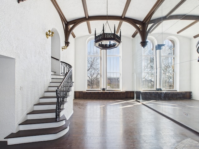 5555 S Everett Ave Unit B3-4, Chicago, IL 60637 - interior space featuring stairs, a towering ceiling, wood finished floors, arched walkways, and a textured wall