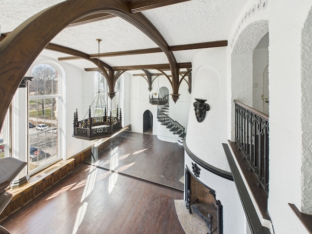 5555 S Everett Ave Unit B3-4, Chicago, IL 60637 - foyer entrance with a textured ceiling, wood finished floors, arched walkways, beamed ceiling, and stairway