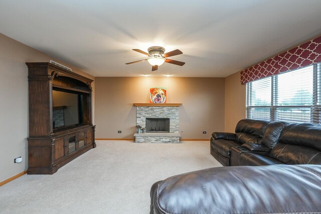 1678 Eagles Lndg N, Manteno, IL 60950 - living room featuring a ceiling fan, baseboards, light colored carpet, and a stone fireplace