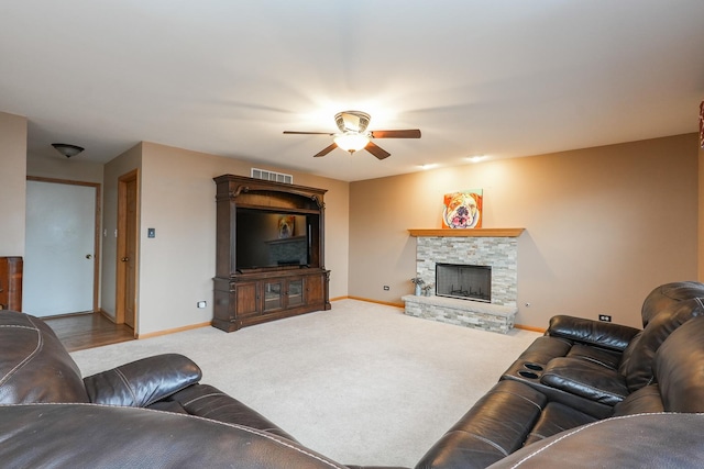 1678 Eagles Lndg N, Manteno, IL 60950 - carpeted living room featuring ceiling fan, baseboards, and a stone fireplace