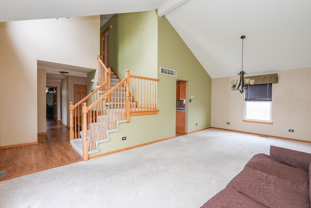 1678 Eagles Lndg N, Manteno, IL 60950 - living room featuring carpet, high vaulted ceiling, a chandelier, baseboards, and stairs