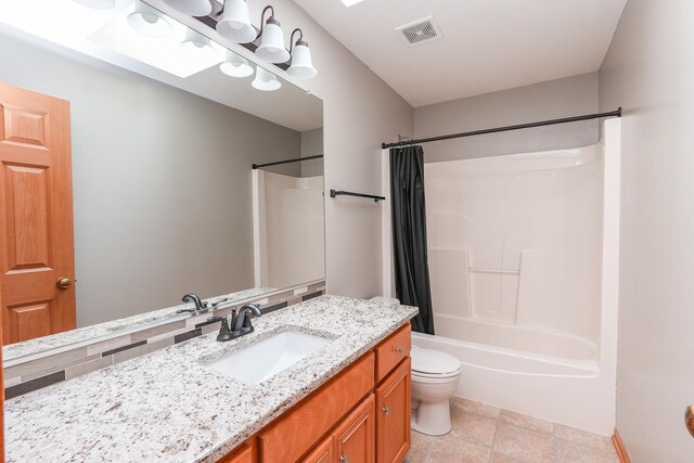 1678 Eagles Lndg N, Manteno, IL 60950 - bathroom with vanity, toilet, shower / bathtub combination with curtain, and stone tile floors