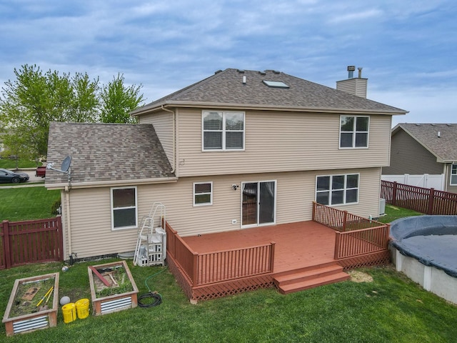 1678 Eagles Lndg N, Manteno, IL 60950 - rear view of house featuring a chimney, a vegetable garden, a wooden deck, and a shingled roof