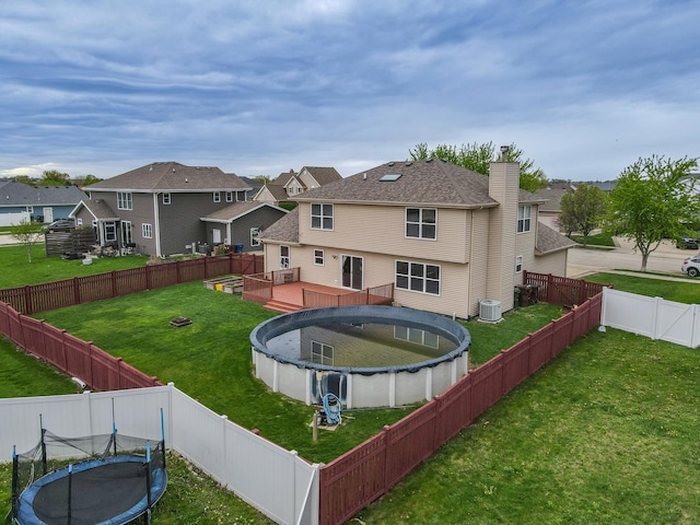 1678 Eagles Lndg N, Manteno, IL 60950 - rear view of property with a trampoline, a deck, central AC unit, and a residential view