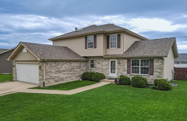 1678 Eagles Lndg N, Manteno, IL 60950 - traditional-style house with a garage, a shingled roof, driveway, and brick siding