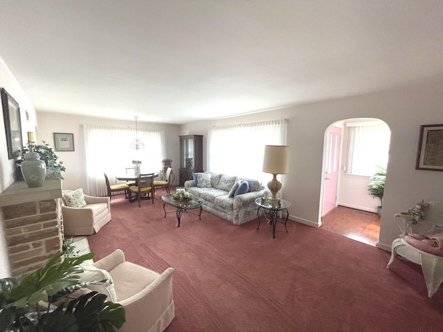 living room featuring carpet and arched walkways