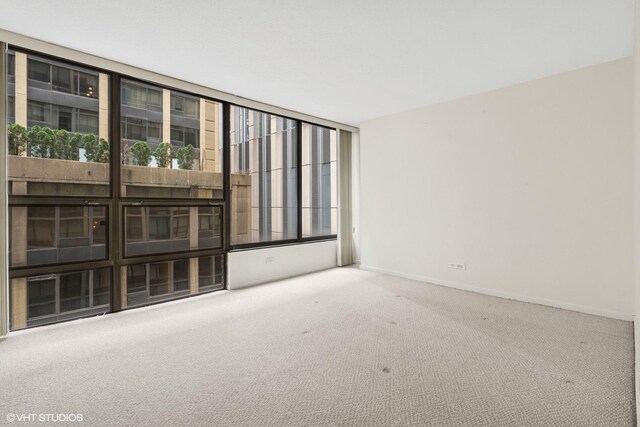230 E Ontario St Unit 1205, Chicago, IL 60611 - carpeted spare room featuring baseboards