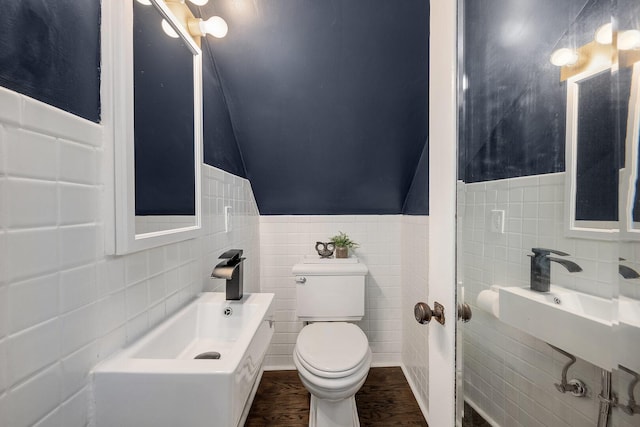 5619 Dunham Rd, Downers Grove, IL 60516 - half bathroom featuring tile walls, toilet, wood finished floors, wainscoting, and vaulted ceiling