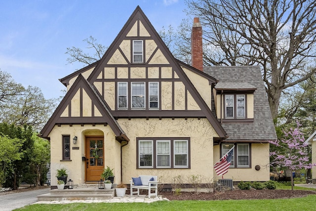 5619 Dunham Rd, Downers Grove, IL 60516 - english style home with stucco siding, roof with shingles, a chimney, and a front lawn
