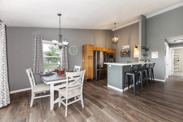 dining area featuring baseboards, a notable chandelier, vaulted ceiling, and dark wood finished floors