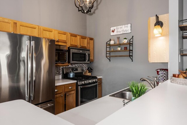 kitchen with decorative backsplash, appliances with stainless steel finishes, open shelves, light countertops, and an inviting chandelier